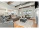 Open-concept living room with hardwood floors, coffered ceilings, fireplace, and large windows at 5820 Brayton Park Pl, Holly Springs, NC 27540