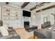 Cozy living room featuring a fireplace, built-in bookshelves, and comfortable seating at 5820 Brayton Park Pl, Holly Springs, NC 27540