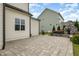 Backyard stone patio with outdoor stone fireplace and view of neighboring home at 5820 Brayton Park Pl, Holly Springs, NC 27540