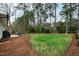 Expansive backyard featuring a patio, lush lawn, mature trees, and mulch beds at 5920 North Hills Dr, Raleigh, NC 27609
