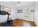 Bedroom or flex space with hardwood floors, closet and a ceiling fan at 5920 North Hills Dr, Raleigh, NC 27609