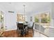 Bright breakfast nook with modern light fixture and view to outdoor patio at 5920 North Hills Dr, Raleigh, NC 27609