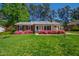 Charming single story home with beautiful landscaping and a lush green lawn at 5920 North Hills Dr, Raleigh, NC 27609