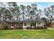 Charming one-story brick home with a well-maintained lawn and mature trees at 5920 North Hills Dr, Raleigh, NC 27609