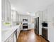 Bright kitchen featuring stainless appliances, white subway tile, and hardwood floors at 5920 North Hills Dr, Raleigh, NC 27609
