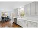 Well-lit kitchen with stainless steel appliances, white cabinets, and breakfast nook at 5920 North Hills Dr, Raleigh, NC 27609