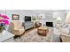 Cozy living room with fireplace, stylish decor, and hardwood floors at 5920 North Hills Dr, Raleigh, NC 27609