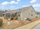 Exterior of home showcasing a cozy screened-in porch, deck, and spacious backyard at 63 Radcliffe Ct, Clayton, NC 27527