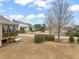 Spacious backyard view from the side of the house, featuring a screened porch at 63 Radcliffe Ct, Clayton, NC 27527