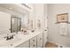 Bright bathroom featuring a double vanity, framed mirrors, and neutral tile flooring at 63 Radcliffe Ct, Clayton, NC 27527