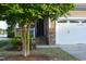 Charming home exterior featuring stone accents, a two-car garage, and lush landscaping for curb appeal at 63 Radcliffe Ct, Clayton, NC 27527