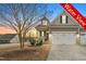 Lovely home with a two-car garage, front porch and appealing water view at 63 Radcliffe Ct, Clayton, NC 27527