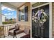 Welcoming front porch featuring seating and a decorative wreath on the door at 63 Radcliffe Ct, Clayton, NC 27527