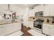 Well-lit kitchen with white cabinets, stainless steel appliances, granite counters, and opens to the living area at 63 Radcliffe Ct, Clayton, NC 27527