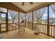 Spacious screened porch with elegant curtains and a comfortable seating area for relaxing at 63 Radcliffe Ct, Clayton, NC 27527