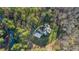 Bird's eye view of a home with mature trees, driveway and well maintained lawn at 65 Gentle Winds Dr, Chapel Hill, NC 27517