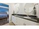 Bathroom featuring double vanity with granite countertop and dual mirrors at 65 Gentle Winds Dr, Chapel Hill, NC 27517