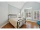 Bedroom with hardwood floors, shuttered windows, and a metal bed frame at 65 Gentle Winds Dr, Chapel Hill, NC 27517