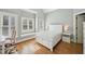 Bedroom featuring plantation shutters, hardwood floors, and neutral tones at 65 Gentle Winds Dr, Chapel Hill, NC 27517