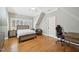 Bedroom with hardwood floors, a fan, and shuttered windows at 65 Gentle Winds Dr, Chapel Hill, NC 27517