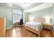 Bright bedroom with vaulted ceilings, light green walls, wood floors, and lots of natural light at 65 Gentle Winds Dr, Chapel Hill, NC 27517