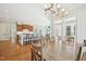 Open-concept dining area connected to a kitchen and seating area with natural light at 65 Gentle Winds Dr, Chapel Hill, NC 27517