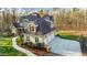 Aerial view of a two-story home showing a large driveway and a three-car garage at 65 Gentle Winds Dr, Chapel Hill, NC 27517