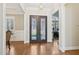 Elegant foyer with hardwood floors, decorative front door, and view into the front office at 65 Gentle Winds Dr, Chapel Hill, NC 27517