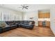 Living room featuring a wet bar with a wine fridge, wood floors, and a black sectional couch at 65 Gentle Winds Dr, Chapel Hill, NC 27517