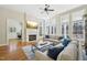 Bright living room with large windows, fireplace, and open access to other rooms at 65 Gentle Winds Dr, Chapel Hill, NC 27517