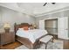Spacious main bedroom with hardwood floors, tray ceilings, and ample natural light at 65 Gentle Winds Dr, Chapel Hill, NC 27517