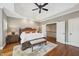 Main bedroom with tray ceiling, hardwood floors, and ample closet space at 65 Gentle Winds Dr, Chapel Hill, NC 27517