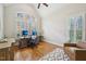 Bright home office with vaulted ceiling, large arched window, and plantation shutters at 65 Gentle Winds Dr, Chapel Hill, NC 27517