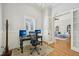 Comfortable office space with a view of an airy living room through a set of bright French doors at 65 Gentle Winds Dr, Chapel Hill, NC 27517