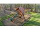 Backyard playground set with slide, climbing wall, swing and tire swing on a bed of mulch at 65 Gentle Winds Dr, Chapel Hill, NC 27517
