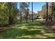 Expansive backyard with well-maintained lawn and treeline at 7004 Bartons Bend Way, Raleigh, NC 27614