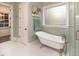 Elegant bathroom featuring a clawfoot tub, tiled floors, and a separate shower area at 7004 Bartons Bend Way, Raleigh, NC 27614