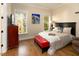 Cozy bedroom with hardwood floors, large windows, and comfortable furnishings at 7004 Bartons Bend Way, Raleigh, NC 27614