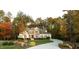 Beautiful, tree-lined property showcasing a meticulously maintained lawn and stone accents at 7004 Bartons Bend Way, Raleigh, NC 27614