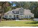 Elegant home with a stone facade, manicured lawn, and lush landscaping at 7004 Bartons Bend Way, Raleigh, NC 27614