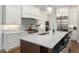 Modern kitchen with quartz countertops, island seating, and stainless steel appliances at 7004 Bartons Bend Way, Raleigh, NC 27614