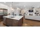 Open-concept kitchen with a large island, stainless appliances, and adjacent living area at 7004 Bartons Bend Way, Raleigh, NC 27614
