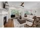 Inviting living room with fireplace, hardwood floors, and backyard views at 7004 Bartons Bend Way, Raleigh, NC 27614