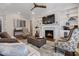 Inviting living room features a fireplace, built-in shelving, hardwood floors, and stylish furniture at 7004 Bartons Bend Way, Raleigh, NC 27614
