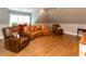 Large living room with leather furniture, hardwood floors and a window view at 7004 Bartons Bend Way, Raleigh, NC 27614