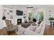 Bright living room featuring a cozy fireplace, built-in shelving, and abundant natural light at 7004 Bartons Bend Way, Raleigh, NC 27614