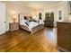 Spacious main bedroom features hardwood floors, large windows, and a cozy seating area at 7004 Bartons Bend Way, Raleigh, NC 27614