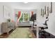 This home office offers a sofa, modern desk and large window at 7004 Bartons Bend Way, Raleigh, NC 27614
