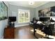 Well-lit office space with hardwood floors, a large window, and functional workspace setup at 7004 Bartons Bend Way, Raleigh, NC 27614