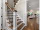 Staircase features wood treads, white risers and an iron balustrade at 7004 Bartons Bend Way, Raleigh, NC 27614
